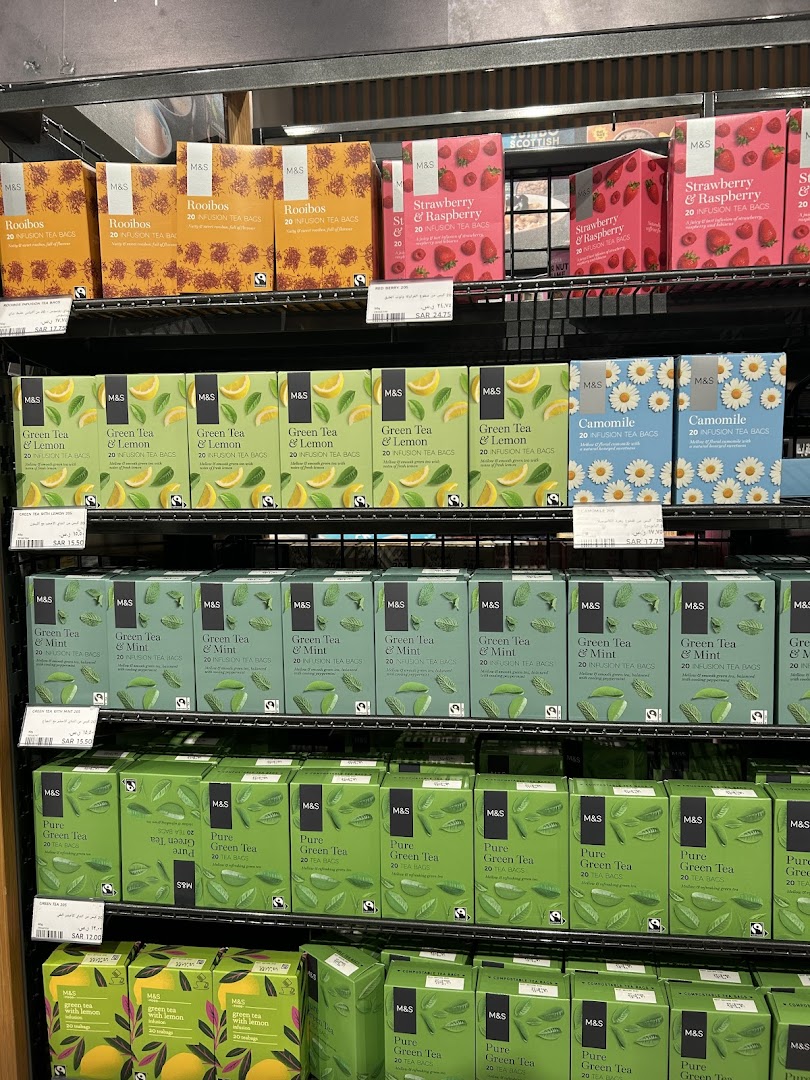 Shelves stocked with various M&S brand tea boxes, including Rooibos, Strawberry & Raspberry, Green Tea & Lemon, Camomile, Green Tea & Mint, and Pure Green Tea.