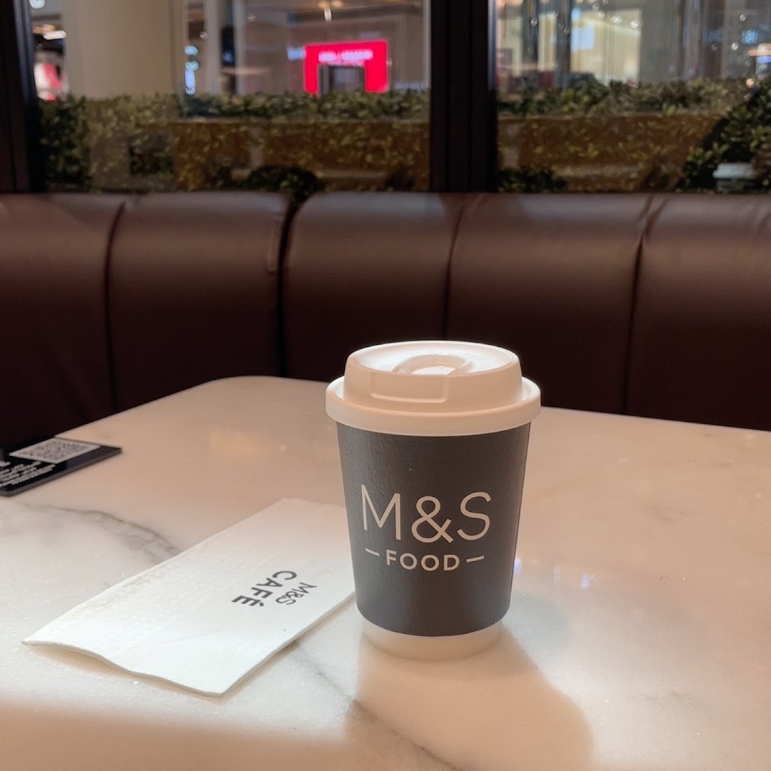 A coffee cup and napkin on a table at MS FOOD and MS CAFE.