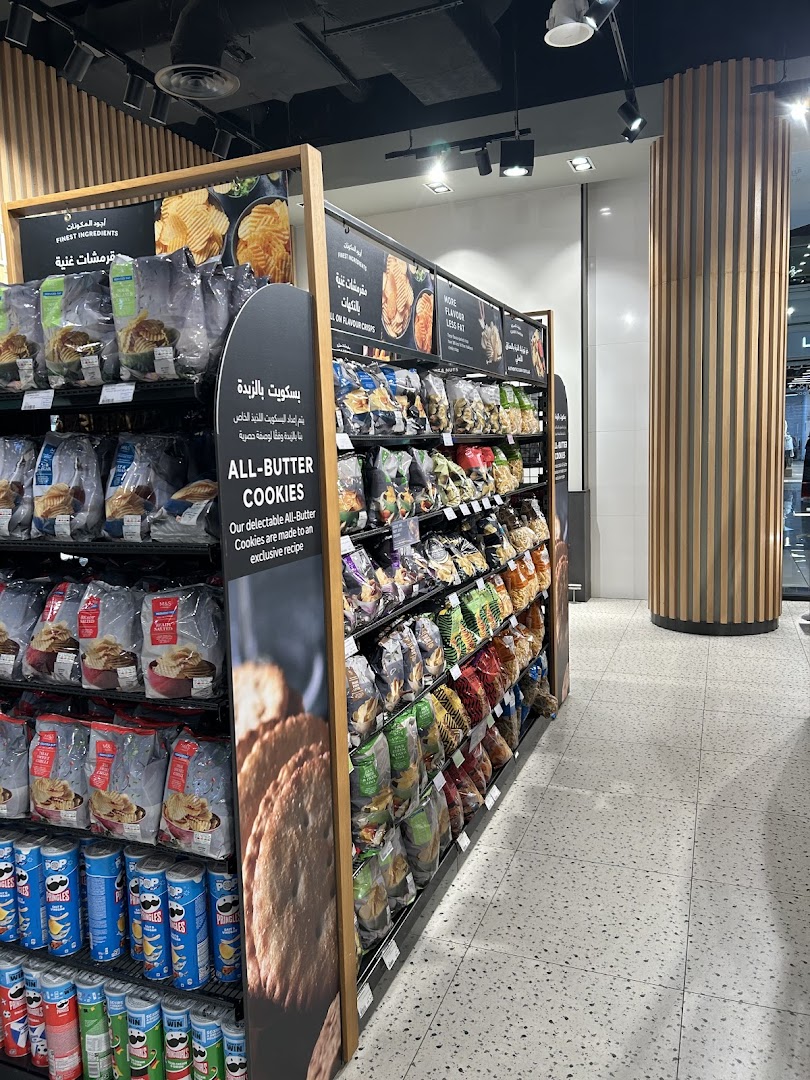 A display of various snacks and cookies in a retail store aisle.