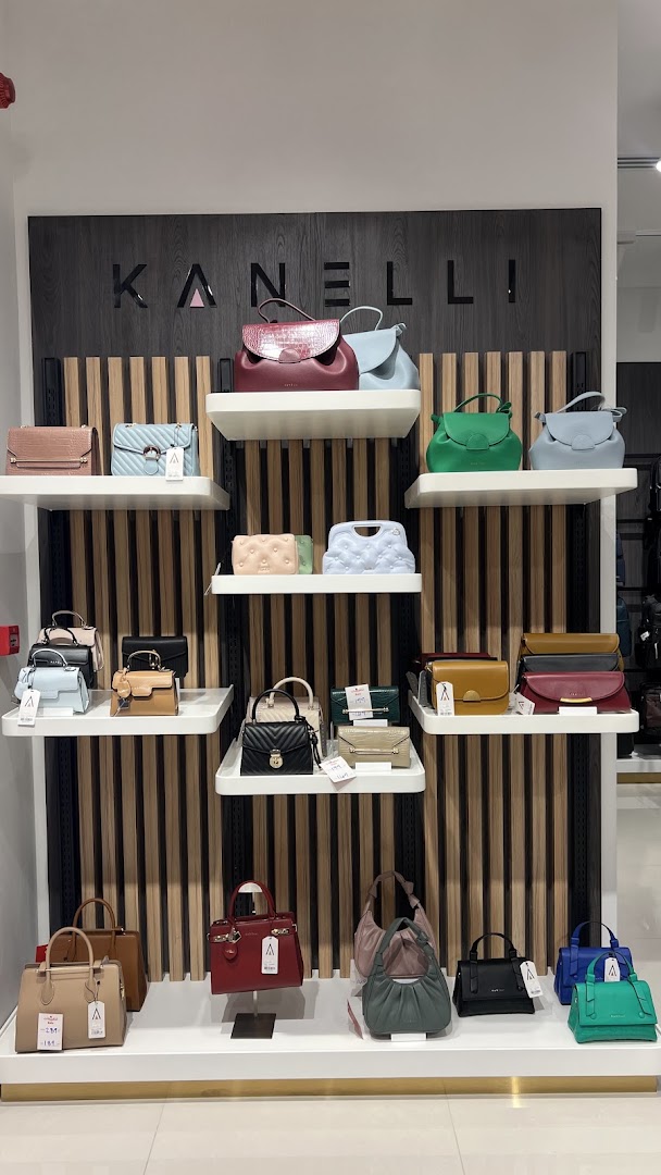 A display of various stylish handbags in different colors and designs.