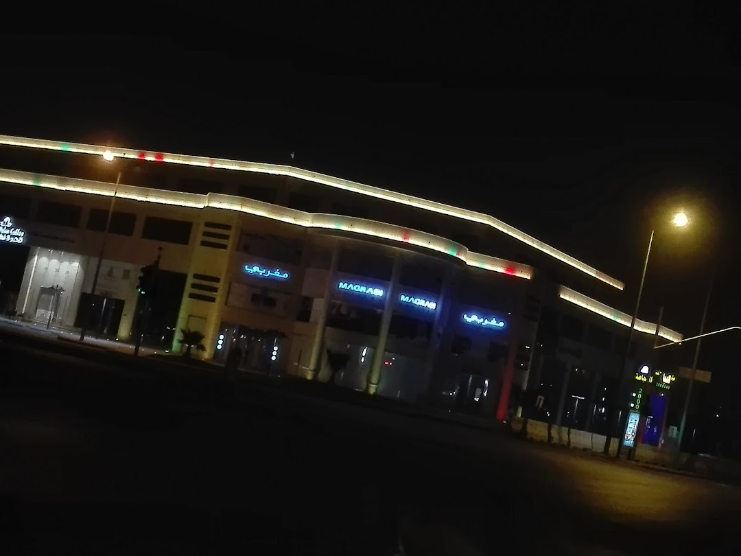 MAGRABi optical shop front at Granada Mall at night, illuminated with neon signs.
