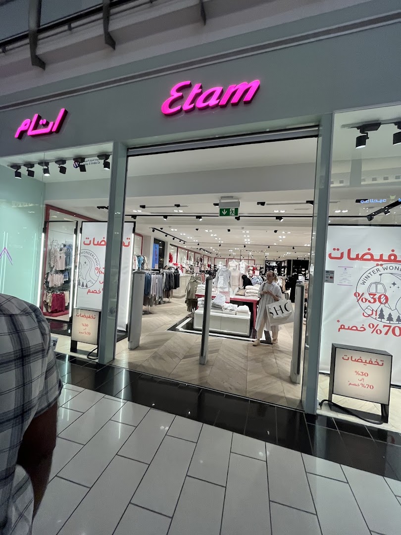 The entrance to the Etam clothing store, showcasing merchandise and sale signs.