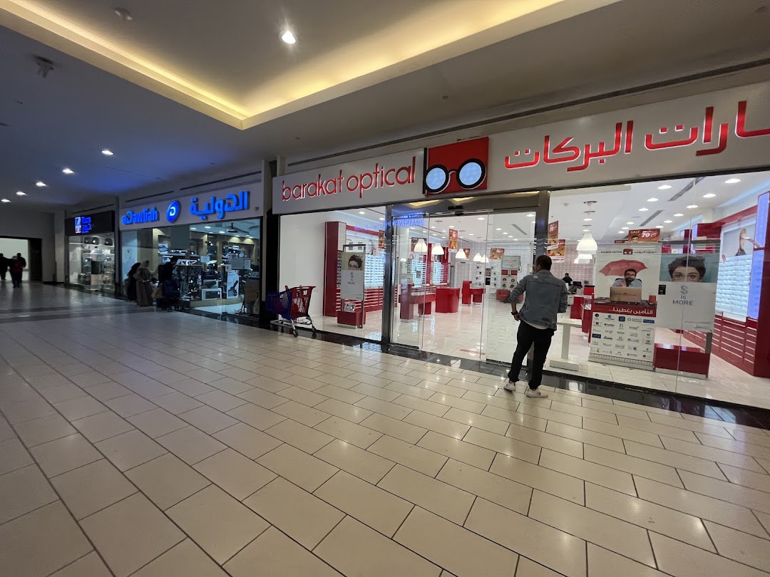 The exterior of the Magrabi optical shop with its bright red and white interior visible.
