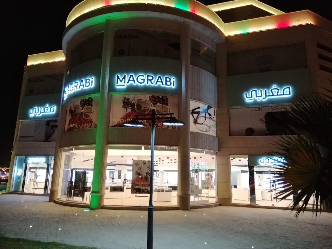 The MAGRABi optical shop front at Granada Mall at night, showcasing eyewear displays.