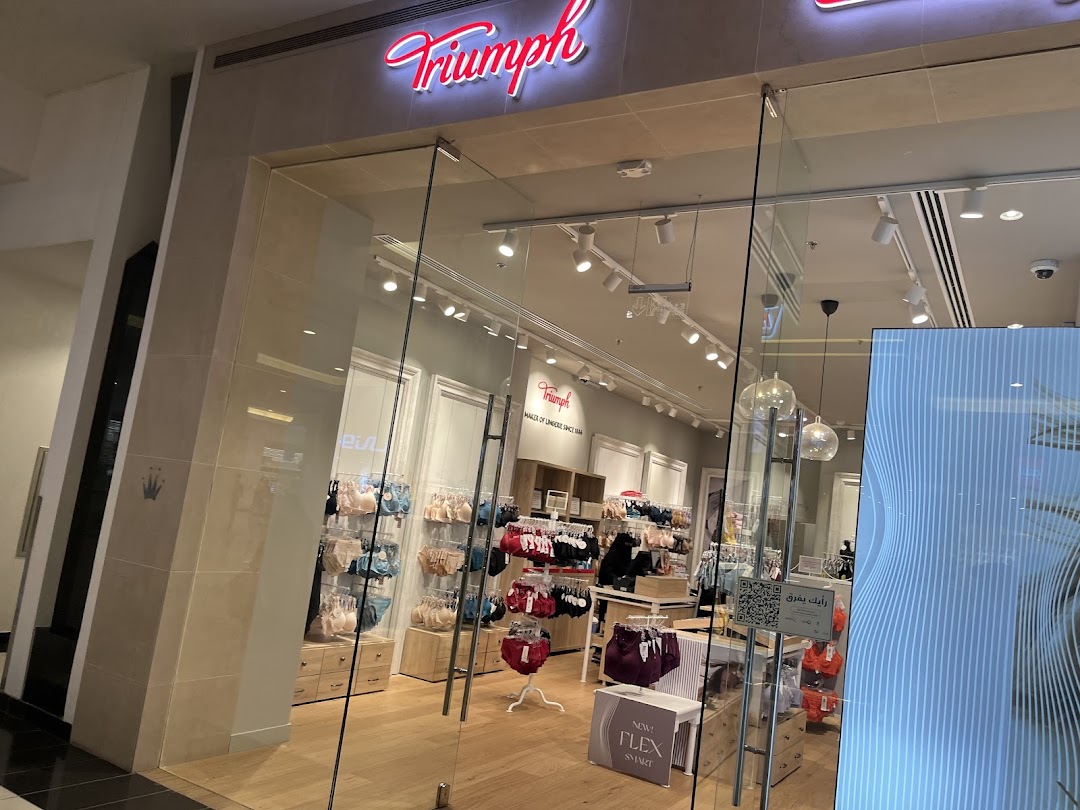 The entrance of a Triumph lingerie store showcasing bras and underwear on display.