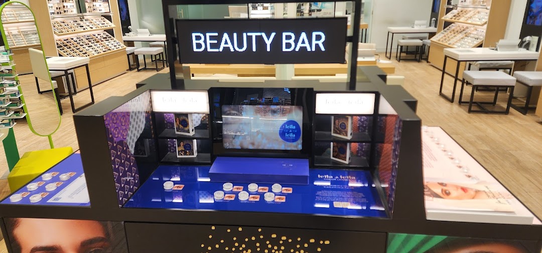 A beauty bar display featuring contact lenses and eye makeup products.
