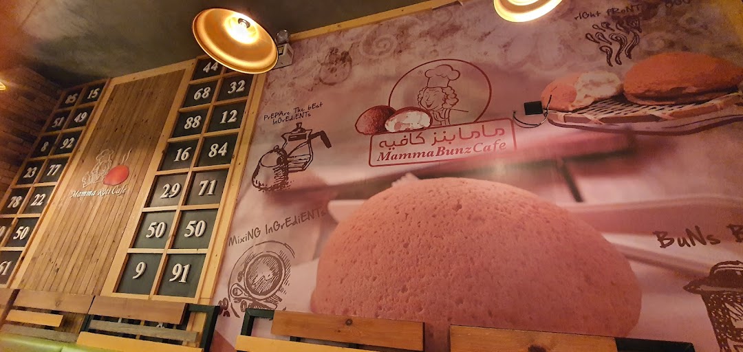 Interior view of MammaBunz Cafe with a large bun graphic and decorative numbers on the wall.