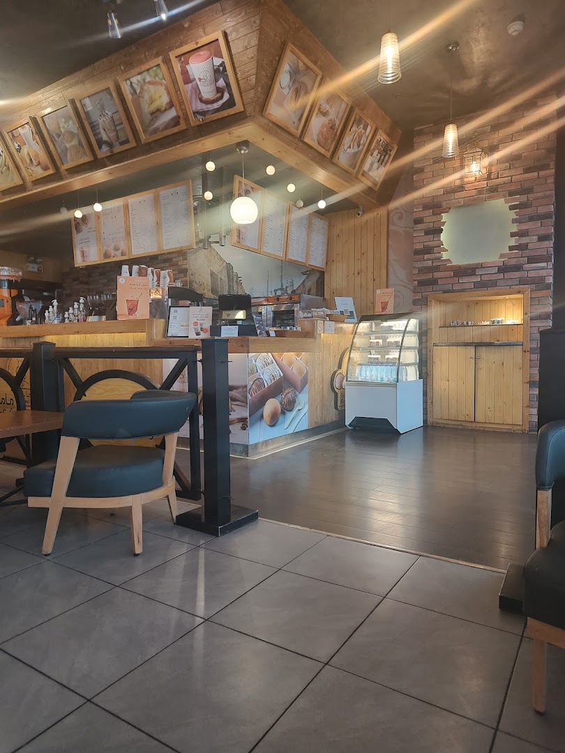 Interior view of MammaBunz Cafe with seating, counter, and display cases.