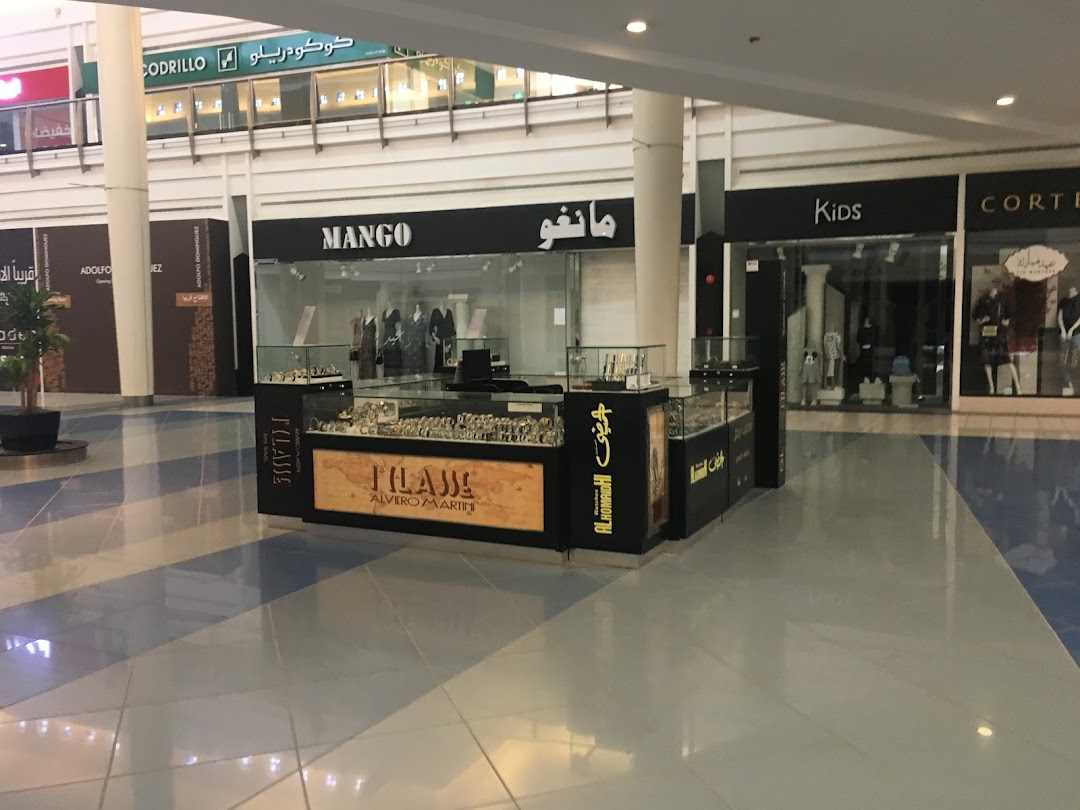 The Mango store entrance with display cases showcasing watches and accessories.