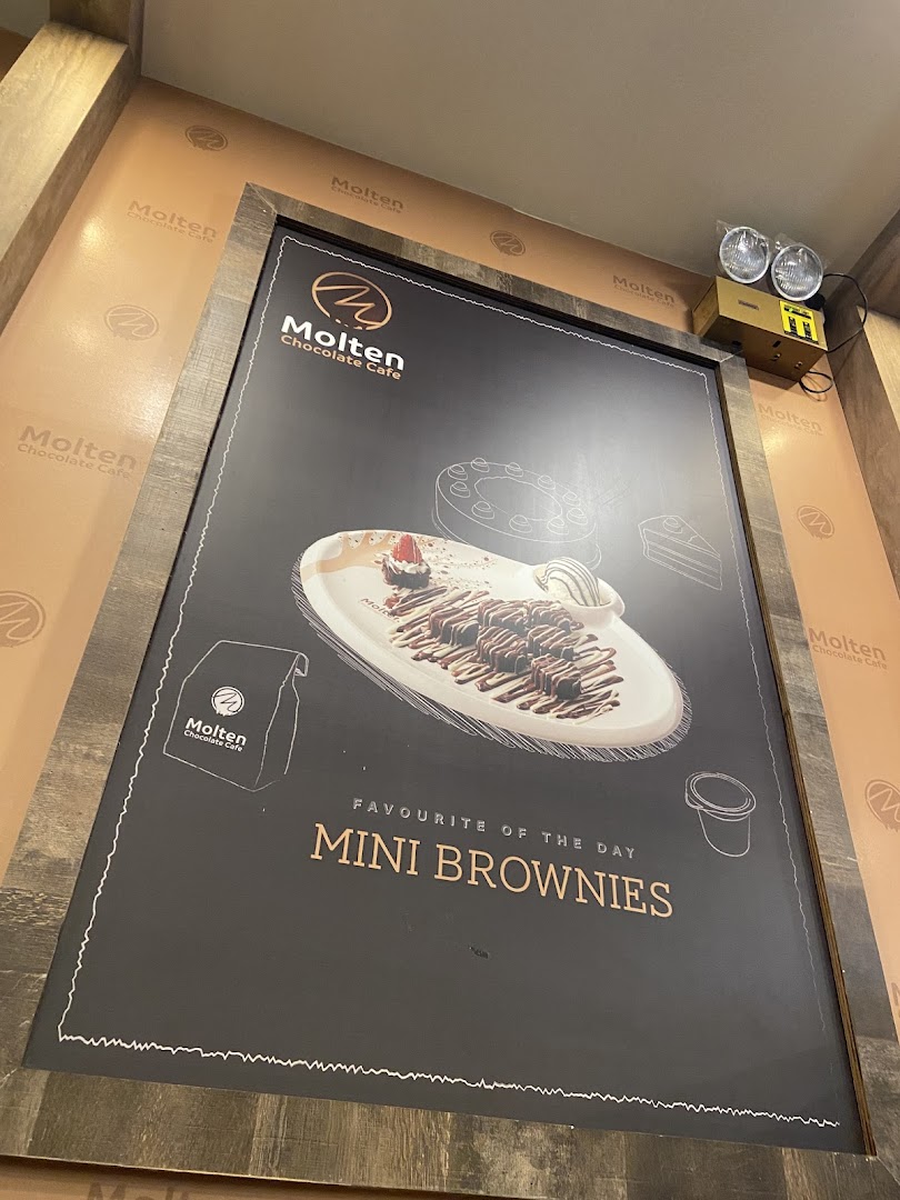 A framed poster advertising Molten Chocolate Cafe's 'Mini Brownies' as the favorite of the day.