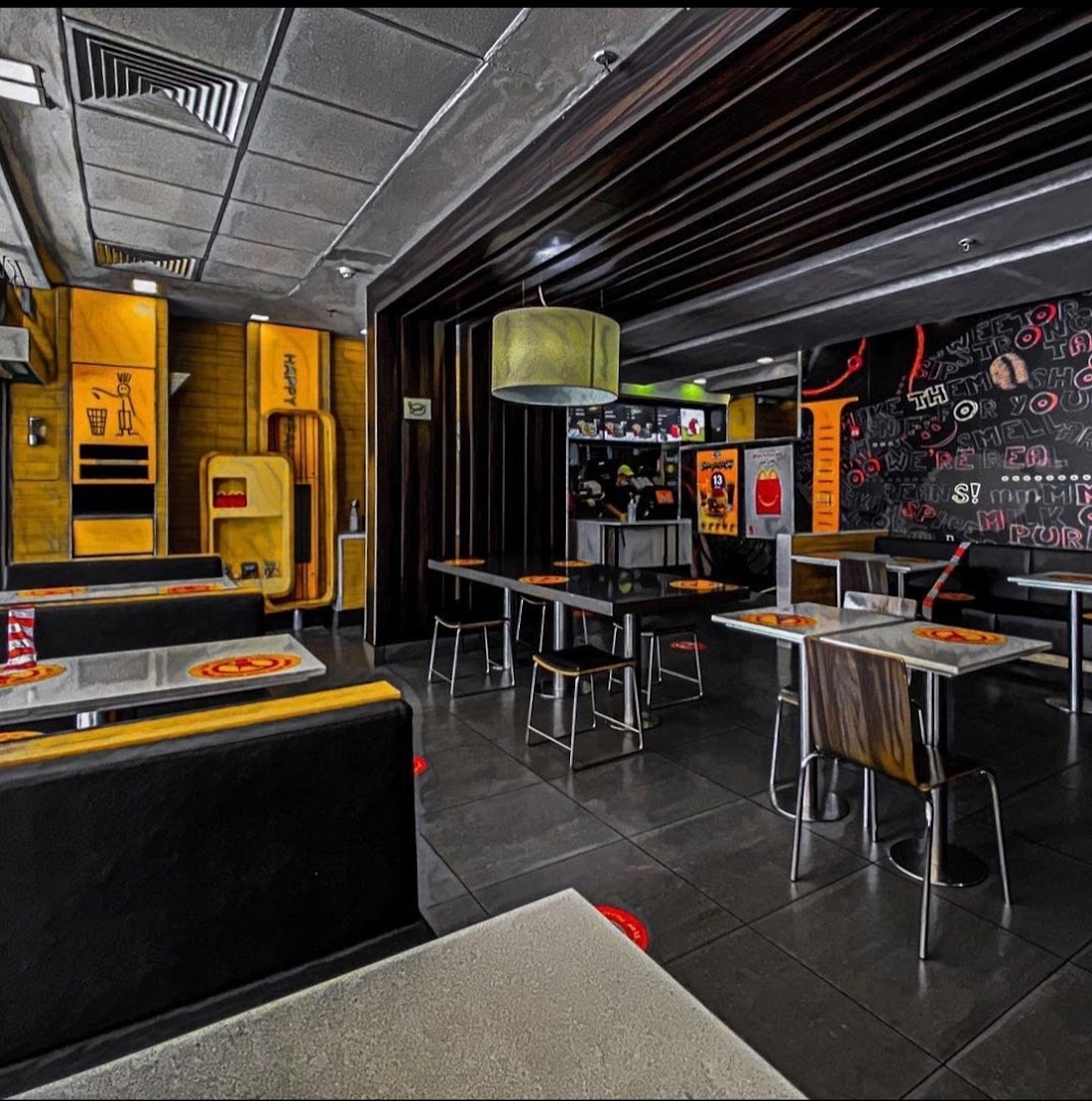 Interior view of a modern McDonald's restaurant with seating and counter area.