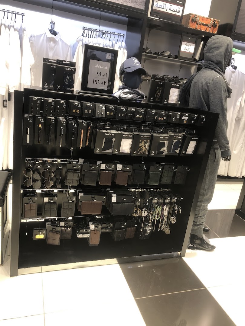 A display of men's accessories including wallets, sunglasses, pens, and face covers at Mihyar.