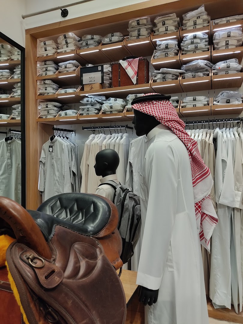 Mannequins display traditional Saudi attire and accessories in a well-lit retail store.