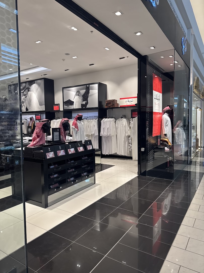 Interior view of a modern clothing store showcasing traditional men's attire.
