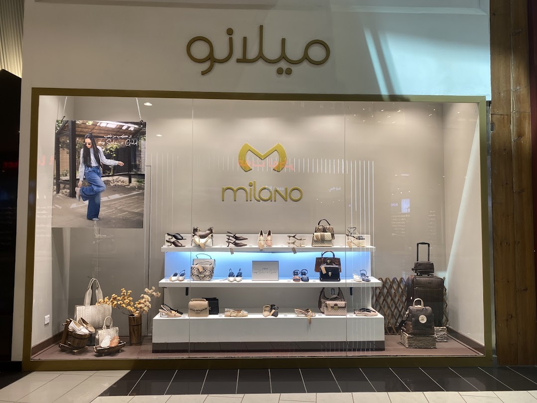 Milano shoe and handbag store window display featuring various stylish footwear and bags.
