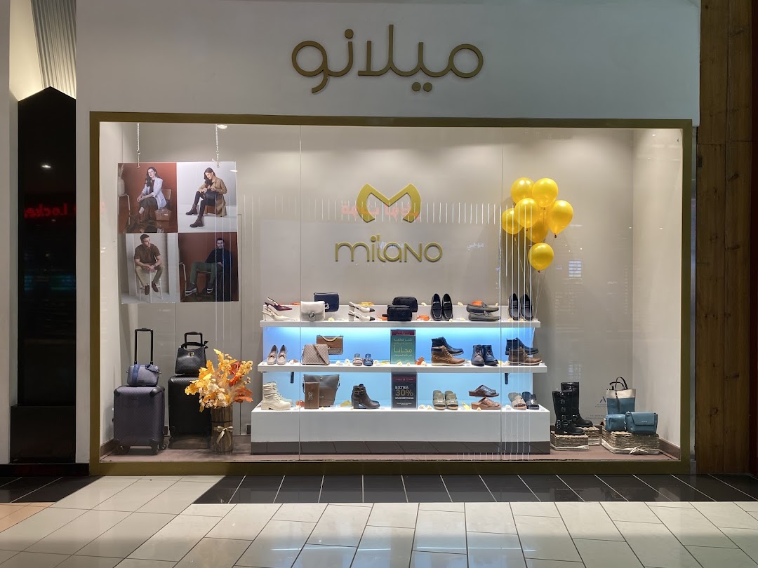 The Milano shop front displays a variety of shoes, bags, and luggage in a well-lit window.