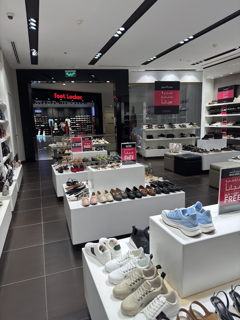 Interior view of a shoe store showcasing various styles of footwear on display.