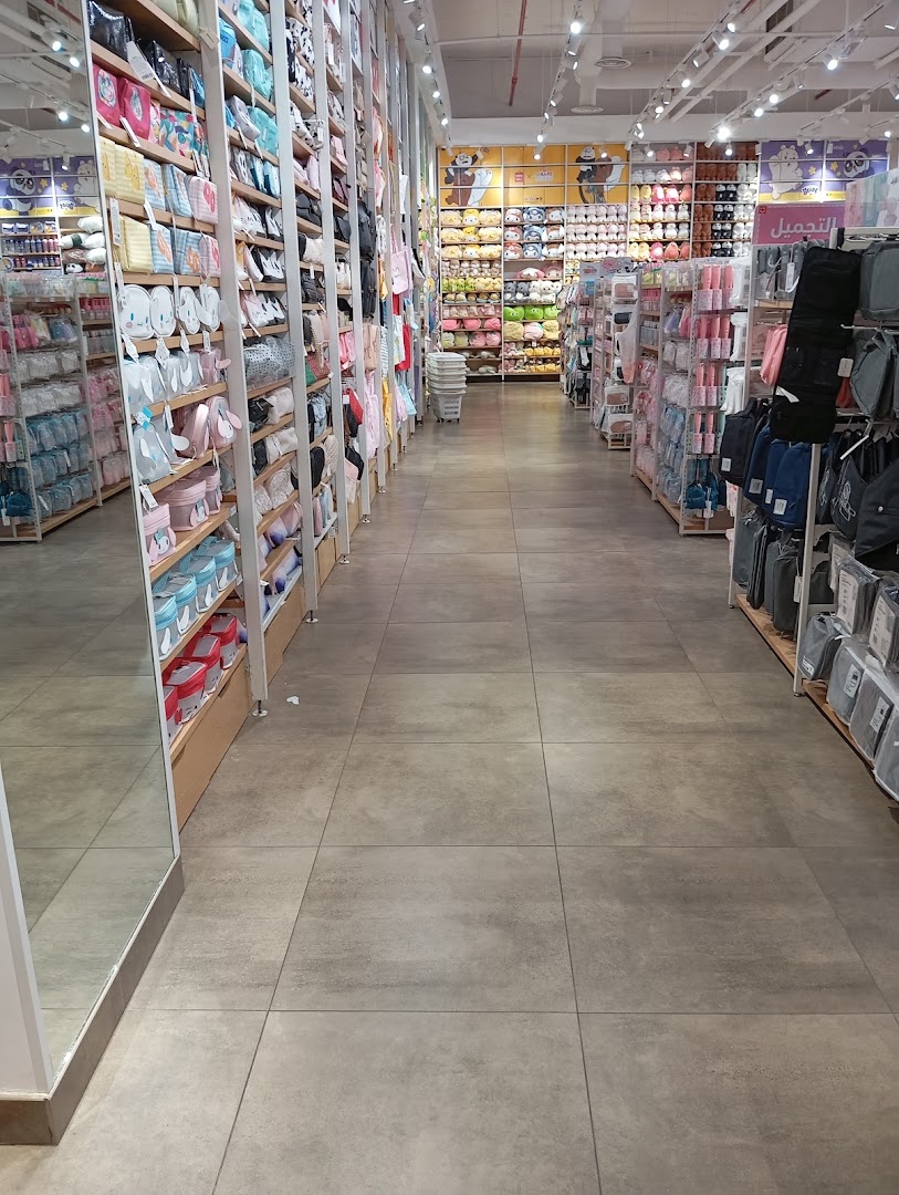 Interior view of a MINISO store showcasing shelves filled with various products like bags and plush toys.