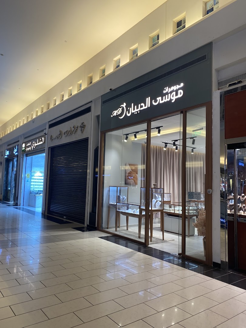 The exterior of a jewelry shop with display cases visible inside.