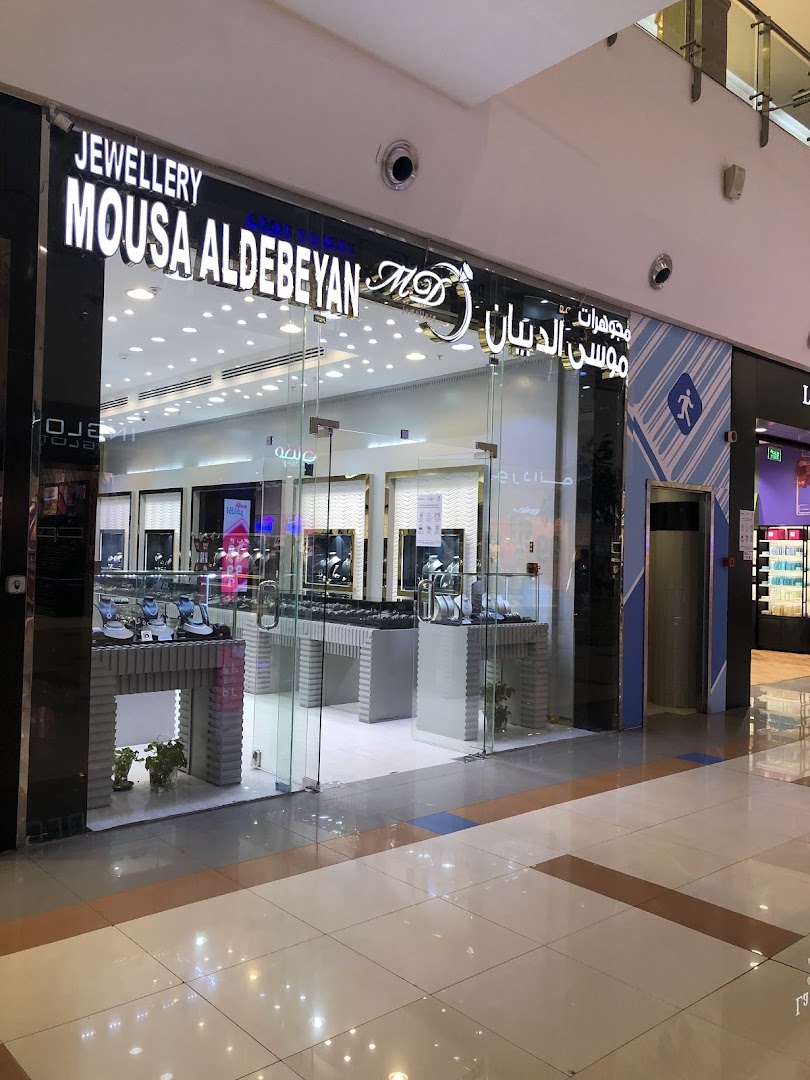 The exterior of a jewelry shop with a glass facade displaying jewelry.