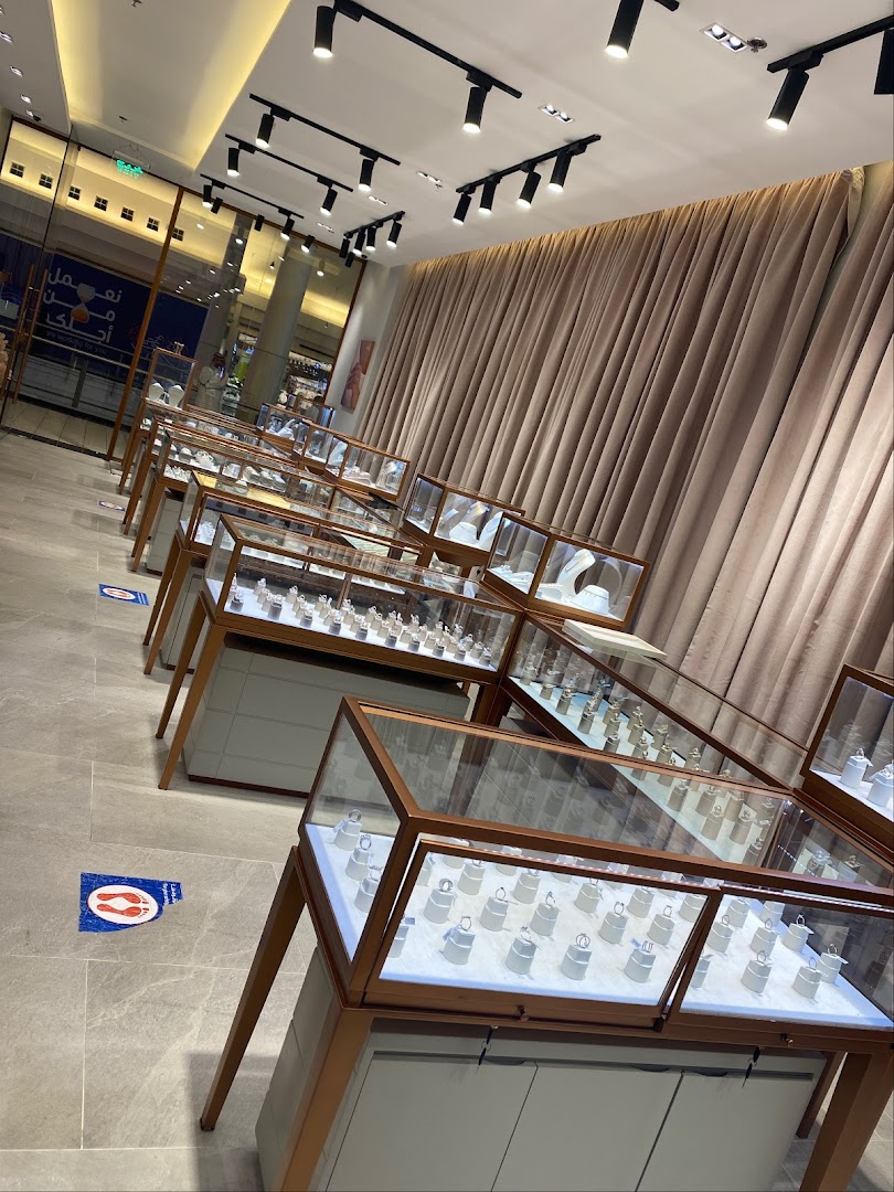 Interior view of a jewelry store with display cases filled with rings and necklaces.