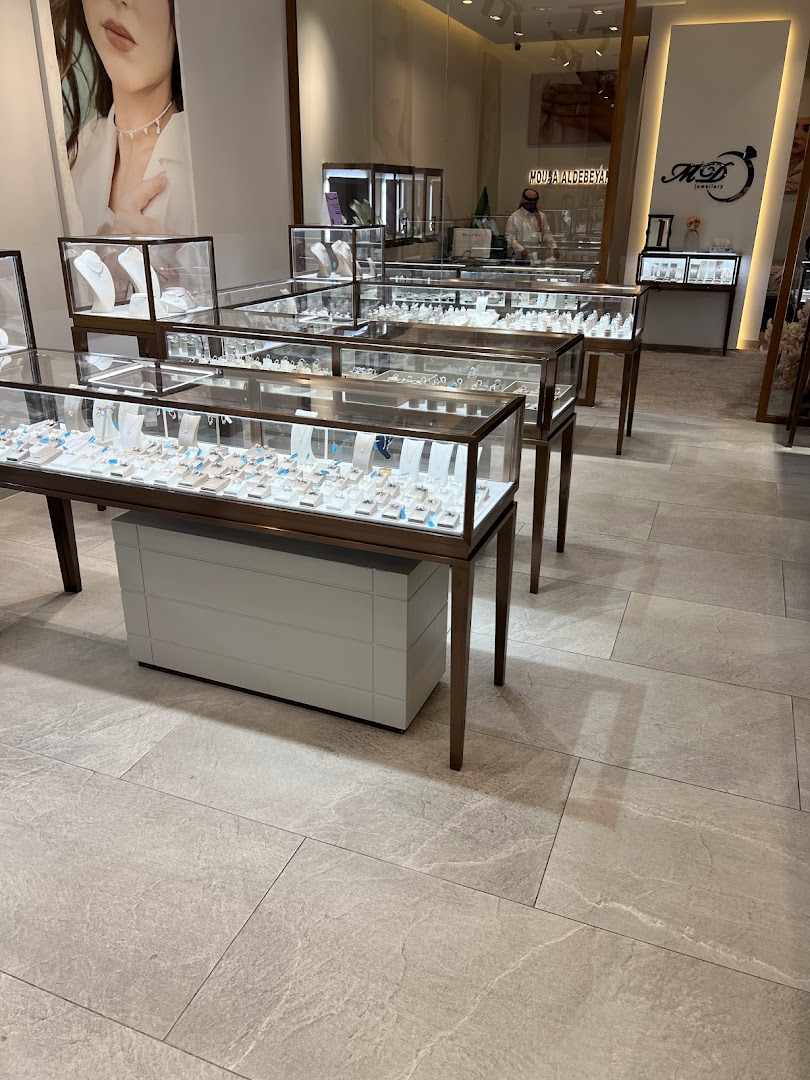 Interior view of a jewelry store showcasing display cases filled with necklaces and rings.