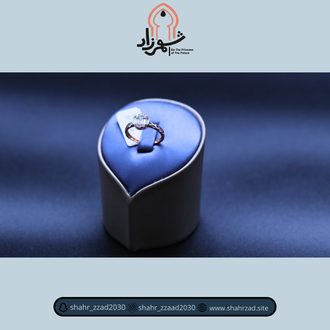 A diamond ring displayed on a stand with the Shahrzad Jewelry logo above.