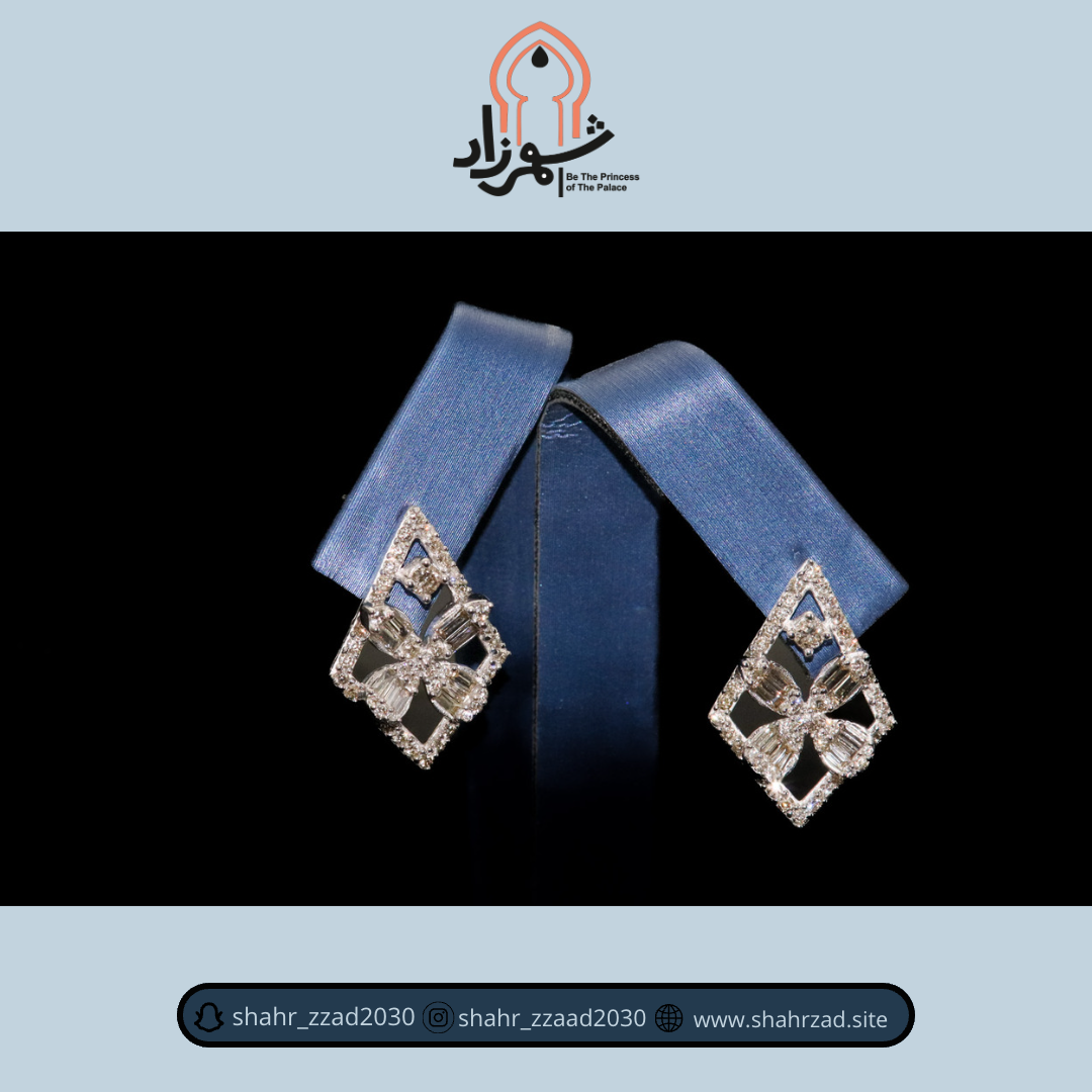 A pair of elegant diamond earrings displayed on blue stands against a black background.