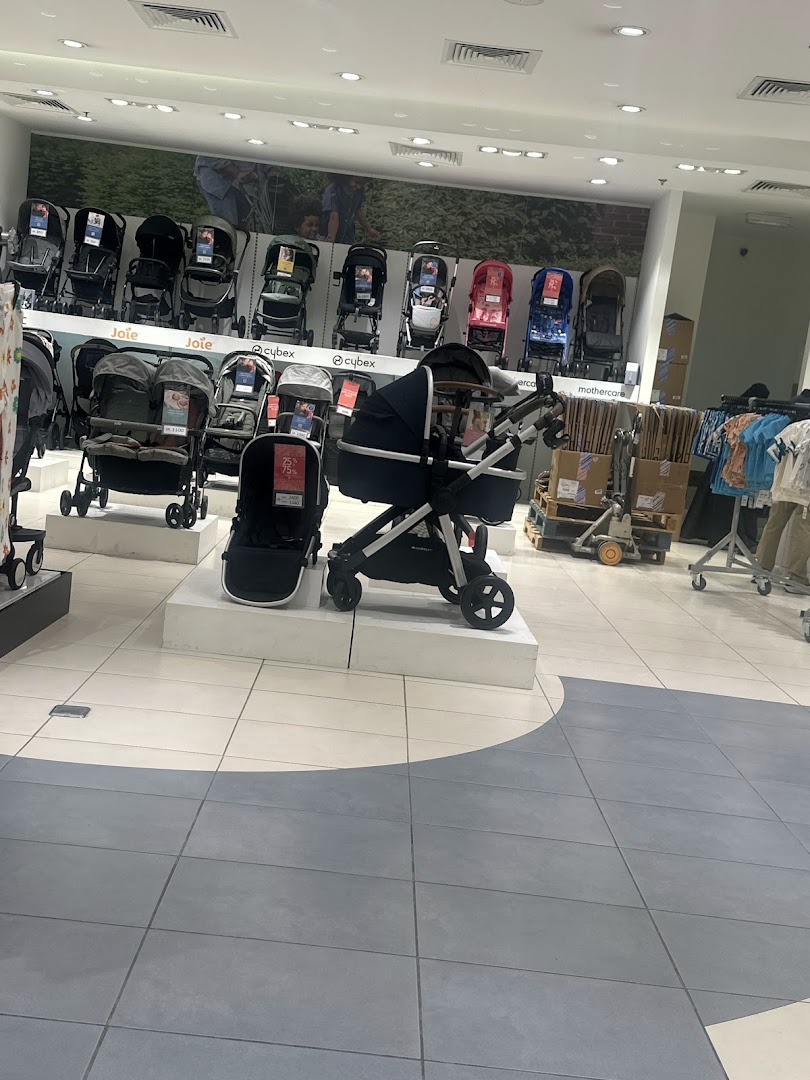 A wide selection of baby strollers displayed in a Mothercare store.