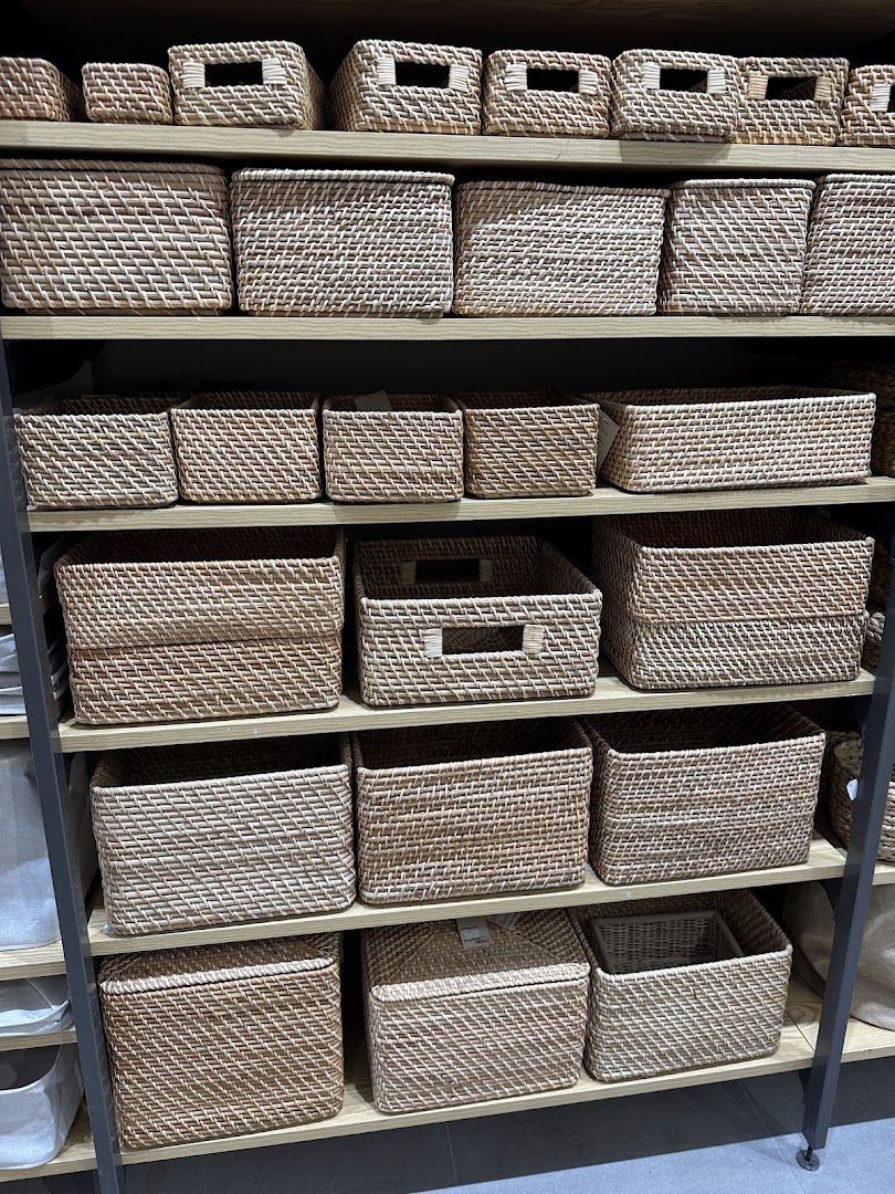 Shelves filled with various sizes of woven storage baskets.