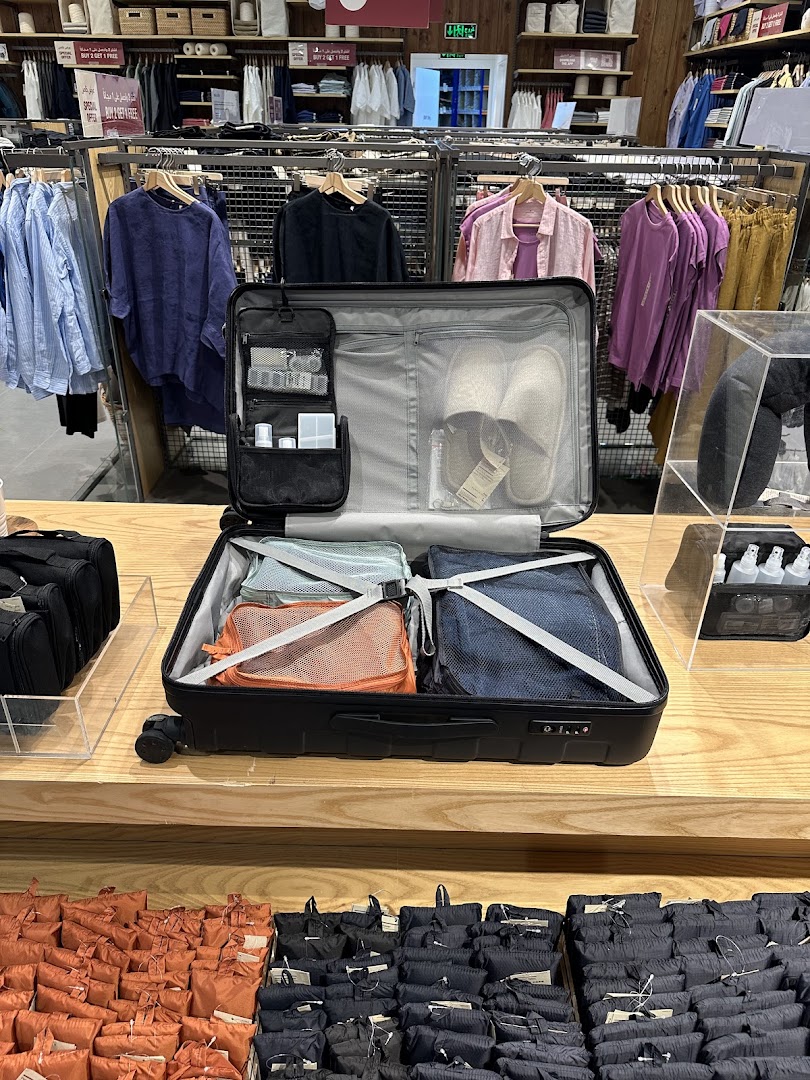 Muji store interior showcasing travel essentials like suitcases, packing cubes, and apparel.