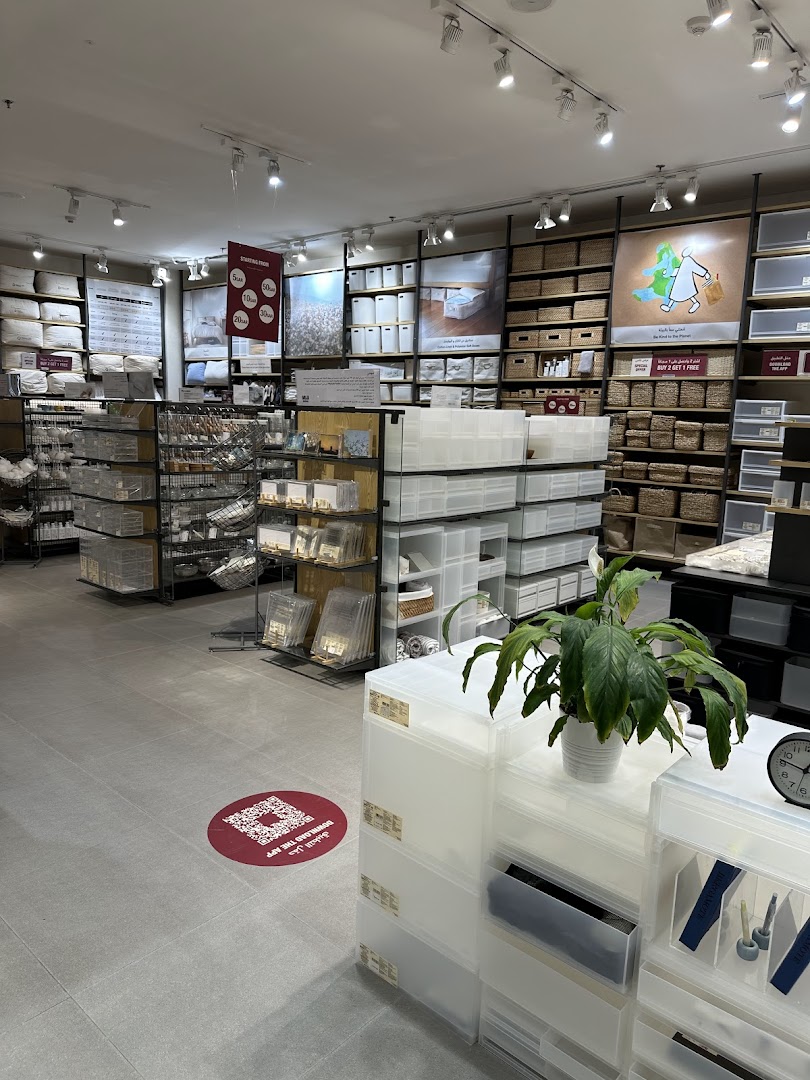 Interior view of a Muji store showcasing storage solutions and home goods.