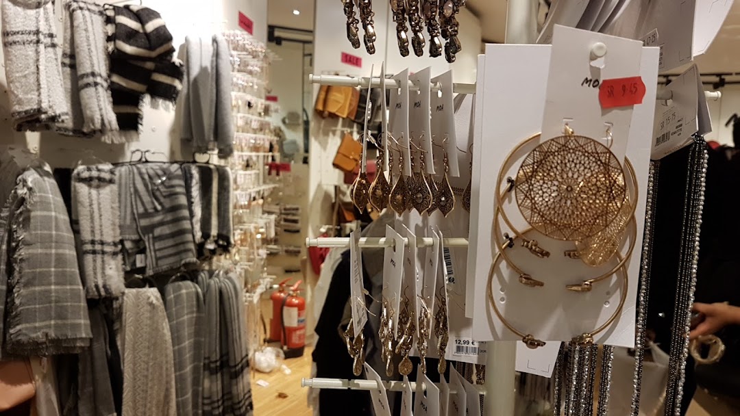 A retail store interior displaying scarves, jewelry, and accessories.