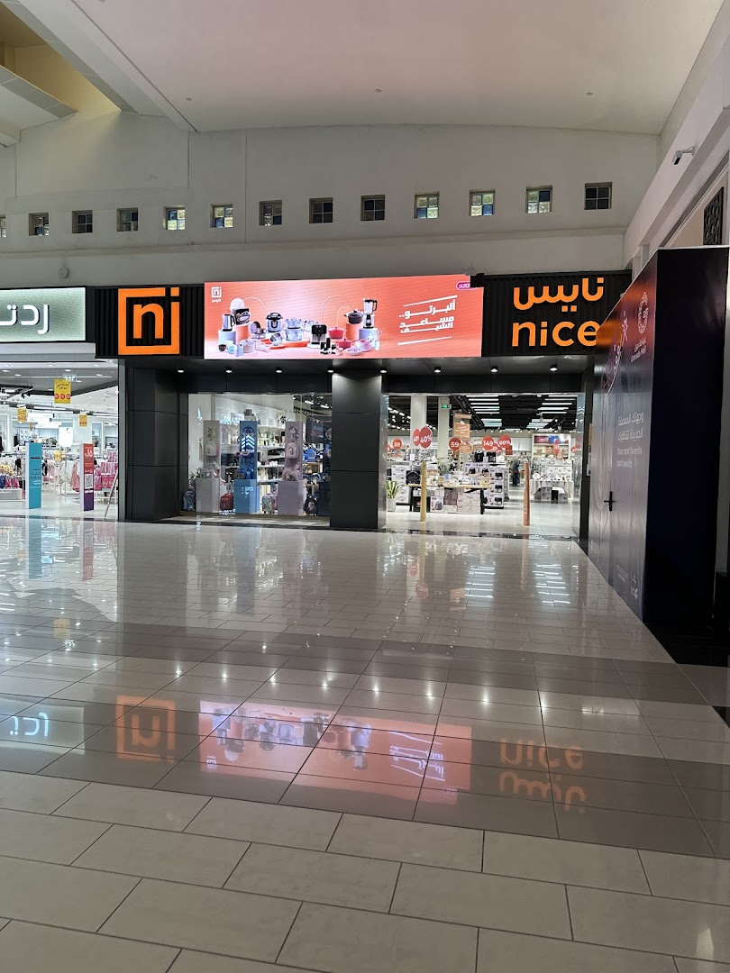 The exterior of the Nice Store shop in a mall, showcasing its signage and entrance.