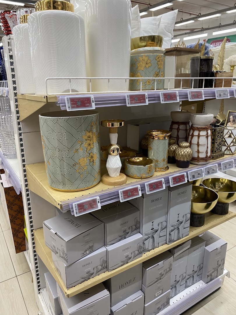 Shelves stocked with decorative home goods including vases, candle holders, and bowls.