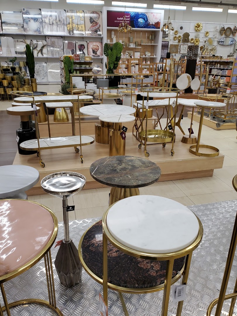 A display of various modern side tables with marble and metallic finishes.