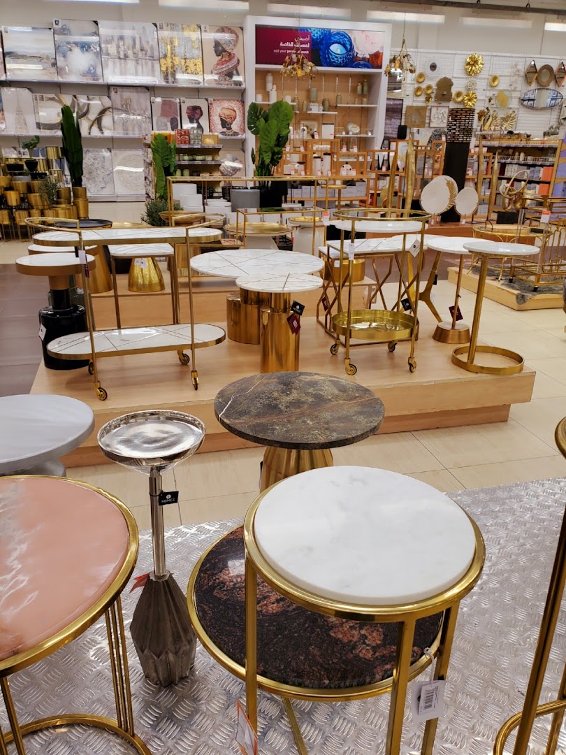 A collection of stylish side tables with marble and metallic finishes displayed in a retail store.