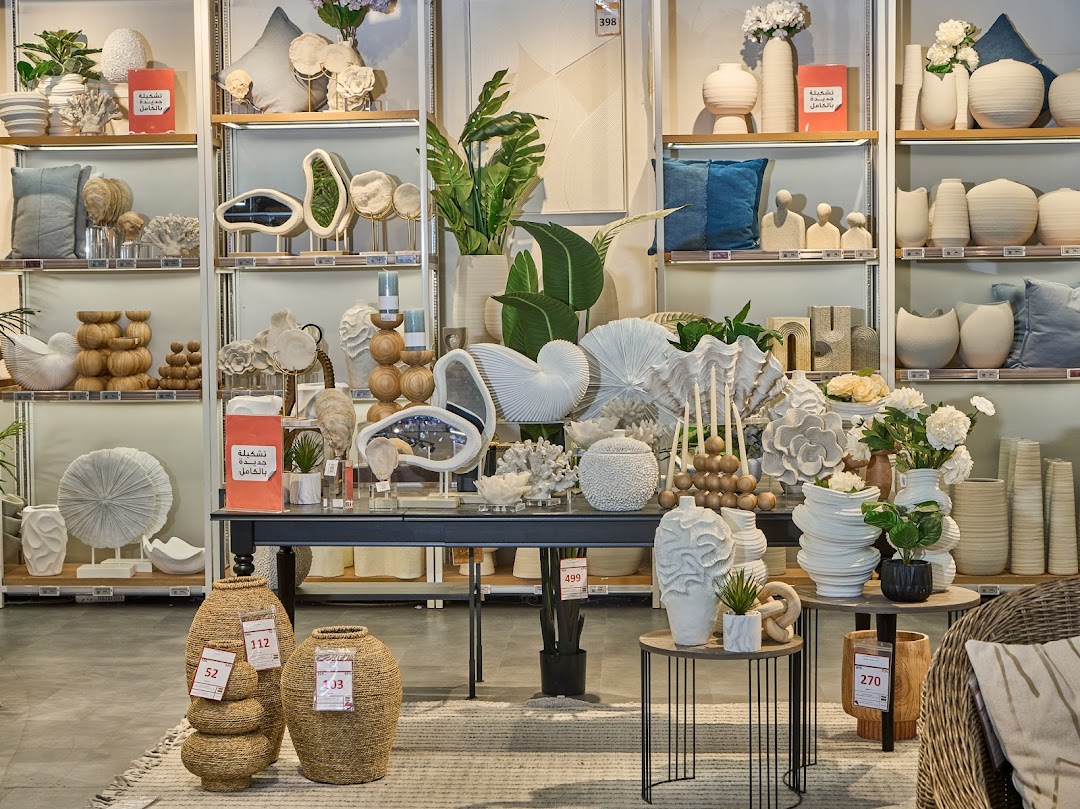 A well-lit store interior showcasing a variety of decorative home goods and vases.