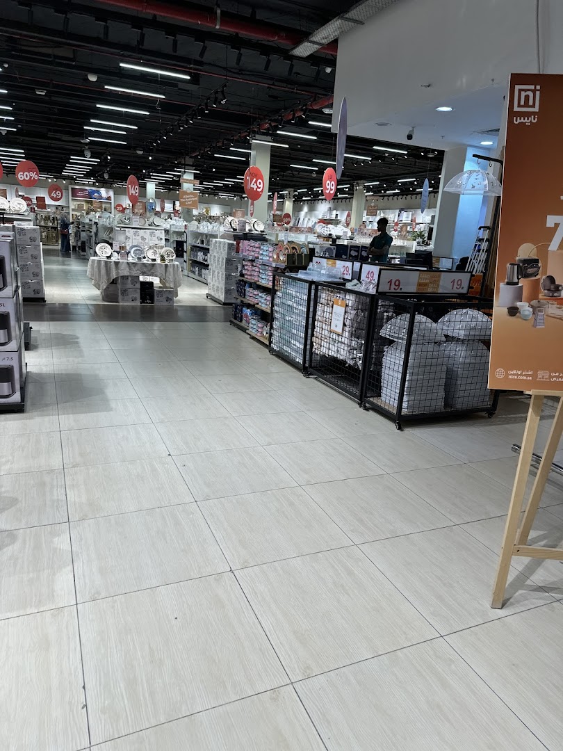 Interior view of a well-lit retail store with aisles of merchandise and price tags.