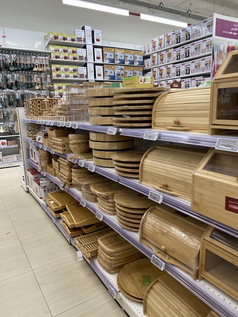 Shelves stocked with various kitchenware, including cutting boards, bread boxes, and storage containers.