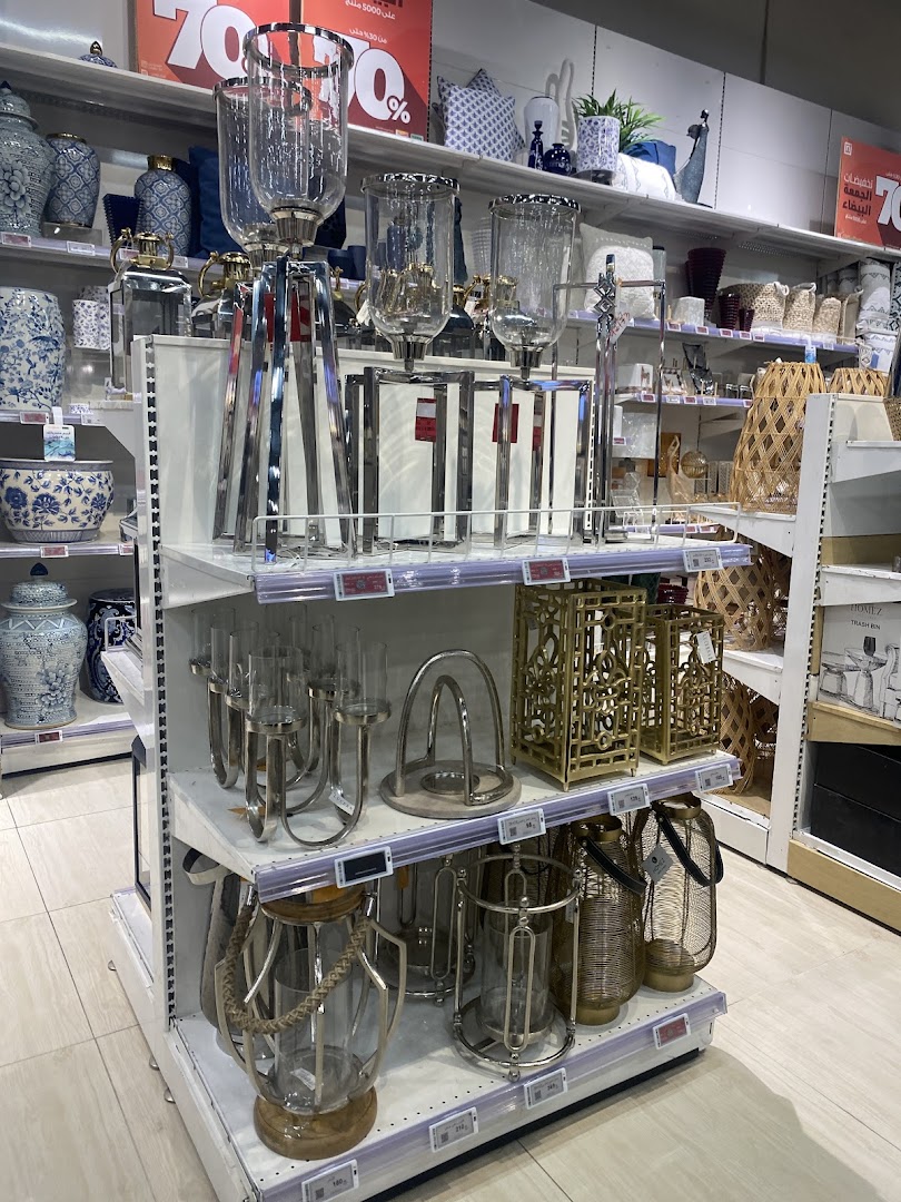 Shelves filled with decorative home goods, including lanterns, vases, and candle holders.