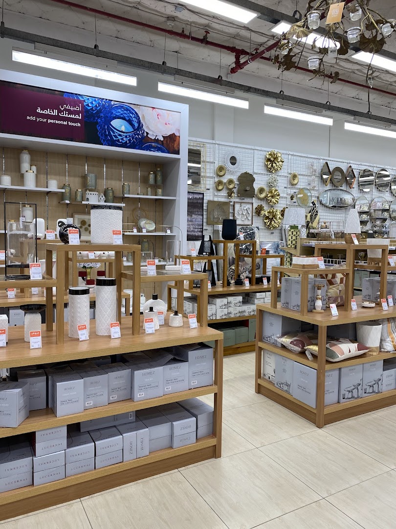 Interior view of a home decor store showcasing shelves filled with decorative items and packaged goods.
