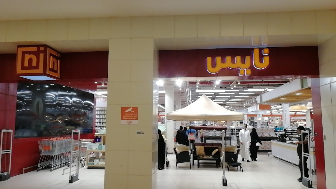 The entrance to Nice Store, a retail shop with a prominent sign and displays of merchandise.