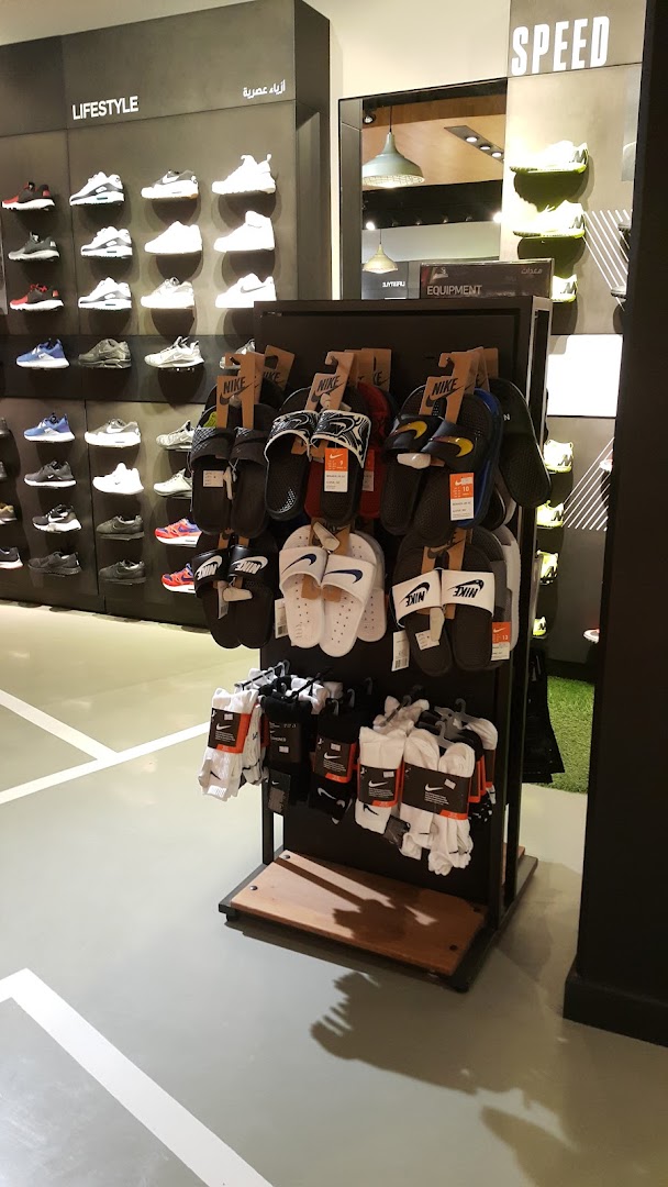 Interior view of a Nike store showcasing various footwear and socks on display.