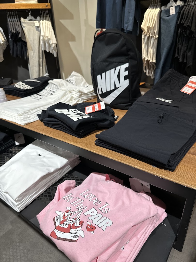 A display of Nike apparel including t-shirts, shorts, and a backpack.