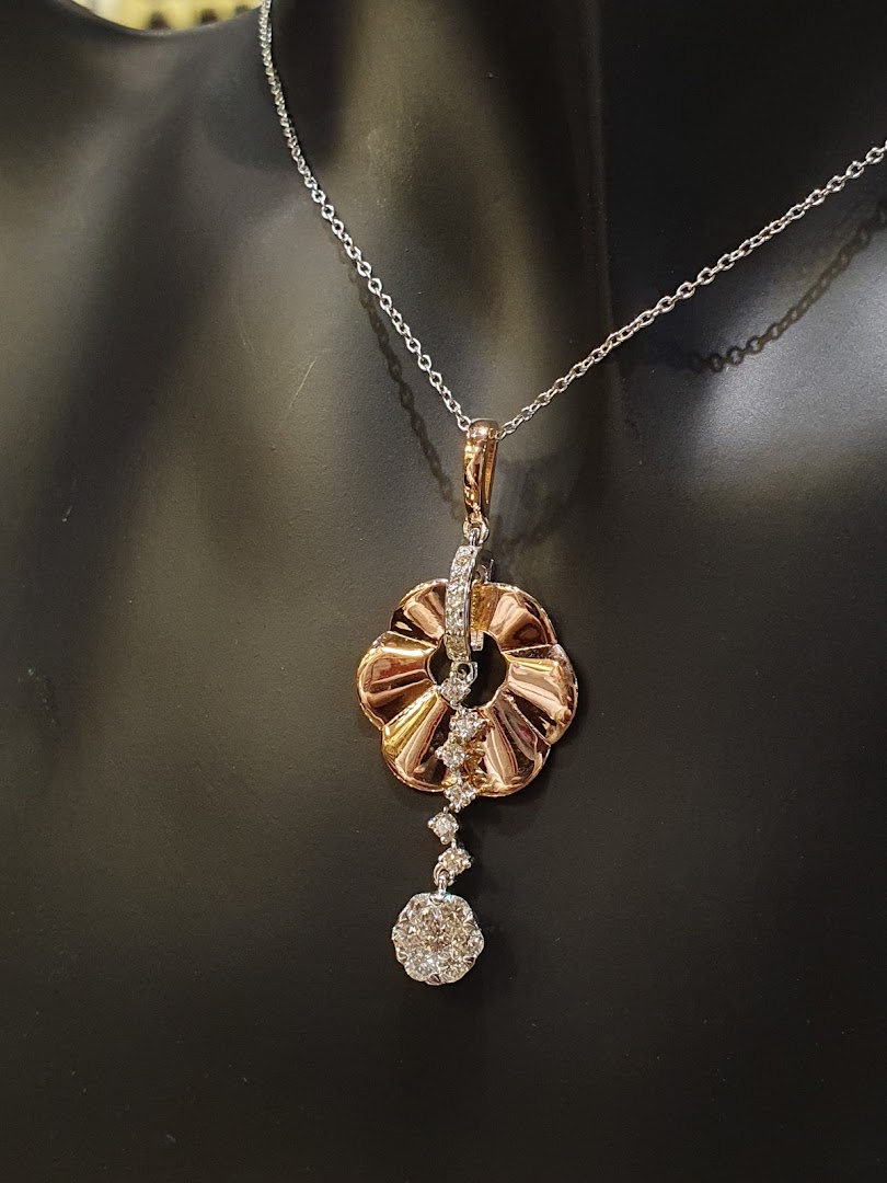 A stunning rose gold and diamond pendant necklace displayed on a black mannequin.