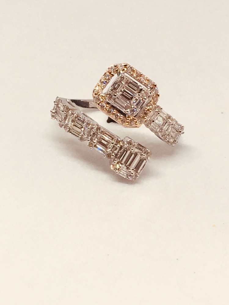 A stunning diamond ring with baguette and round cut diamonds on a white background.