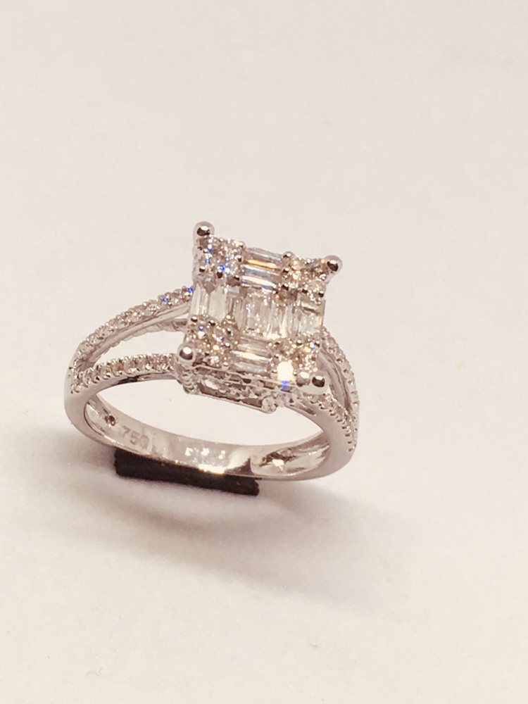 A stunning diamond ring with baguette and round-cut stones set in white gold.