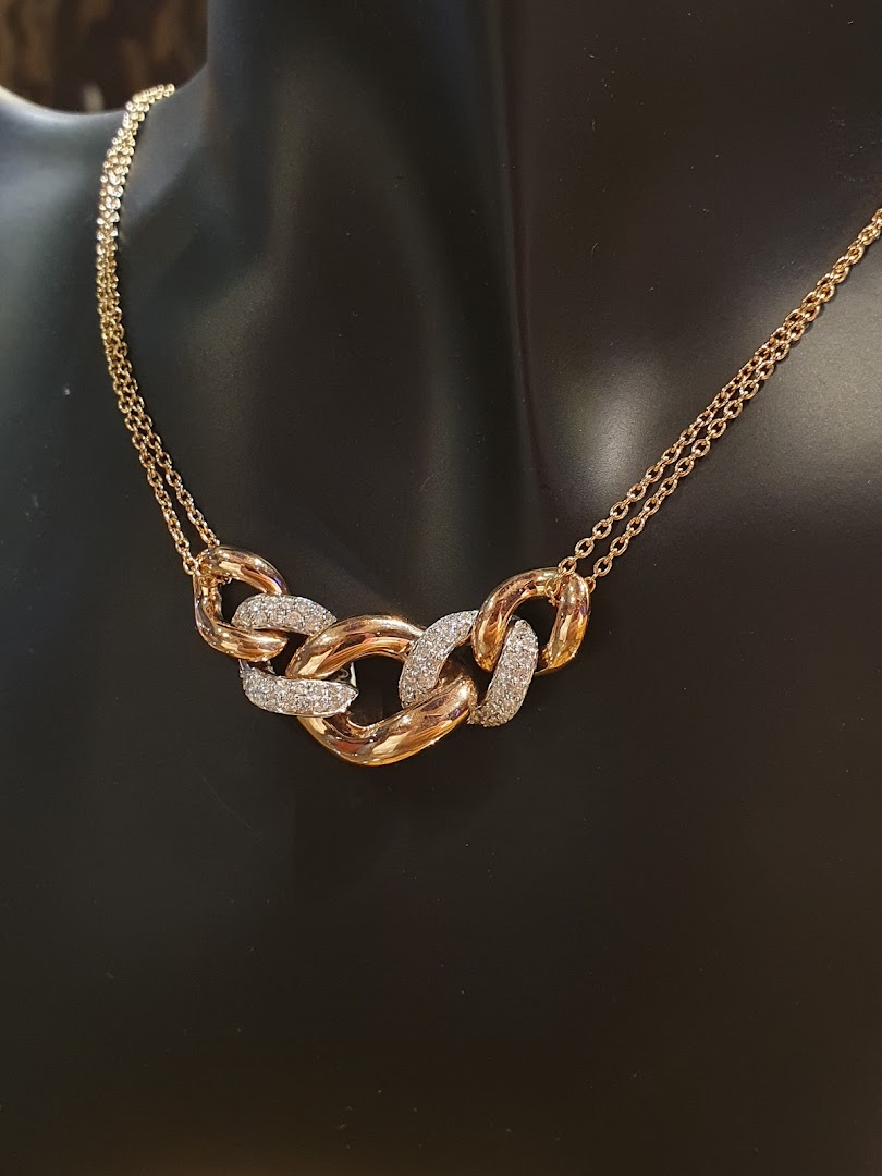 A stunning gold and diamond necklace with chunky links displayed on a black mannequin.