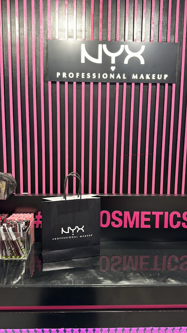 A NYX Professional Makeup shopping bag and products displayed in a store.